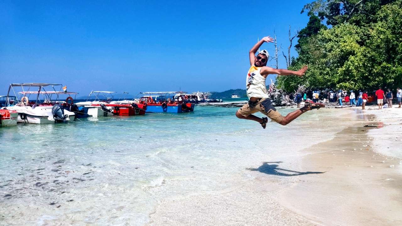 traveler jumping in joy by the sea in Andaman Islands