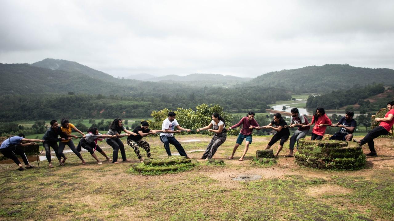 Trekkers enjoying a game of tug of war at Nagara Fort, after a trek to Kodachadri